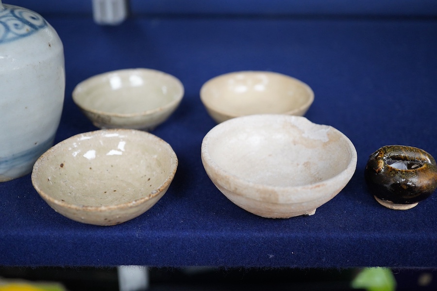 A group of Thai or Annamese miniature pottery vessels and a small blue and white vase, vase 9.5cm high. Condition - poor, fair and good